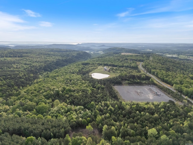 birds eye view of property featuring a view of trees