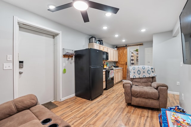 living room featuring ceiling fan, baseboards, a barn door, and light wood-style floors