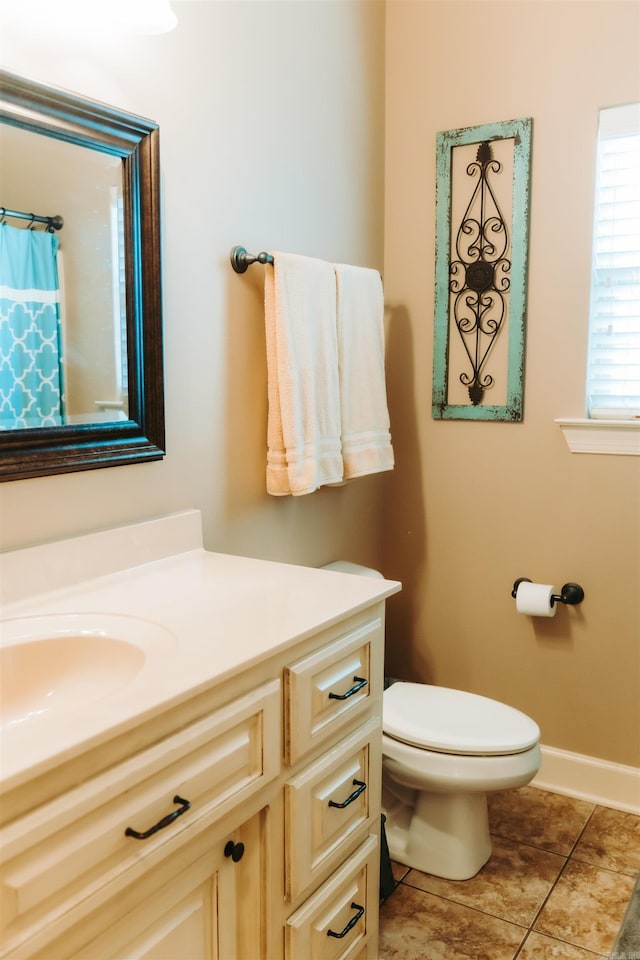 full bath with tile patterned floors, toilet, vanity, and baseboards