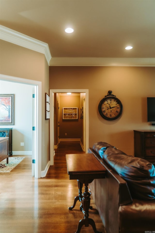 hall with baseboards, recessed lighting, ornamental molding, and wood finished floors