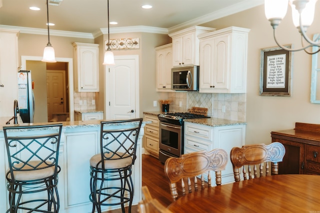 kitchen featuring stainless steel appliances, decorative backsplash, a kitchen bar, decorative light fixtures, and light stone counters