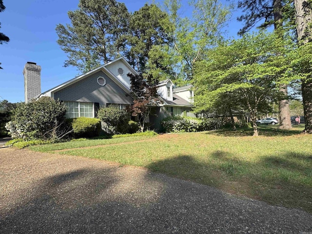 22 Azalea, Magnolia, AR 71753 - view of front of home with a chimney and a front yard