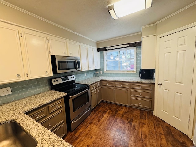 22 Azalea, Magnolia, AR 71753 - kitchen featuring white cabinets, backsplash, appliances with stainless steel finishes, and dark wood-type flooring