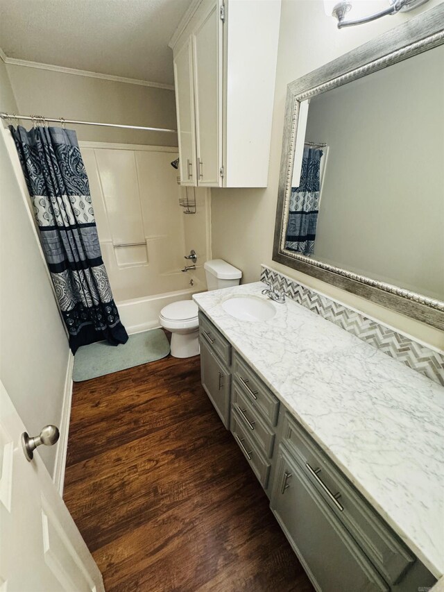 22 Azalea, Magnolia, AR 71753 - full bathroom featuring wood finished floors, shower / bath combination with curtain, ornamental molding, toilet, and vanity