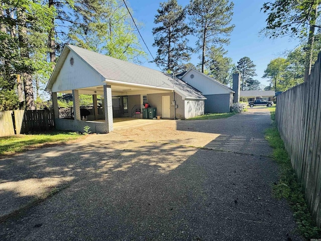 22 Azalea, Magnolia, AR 71753 - view of home's exterior with fence, aphalt driveway, and an attached carport