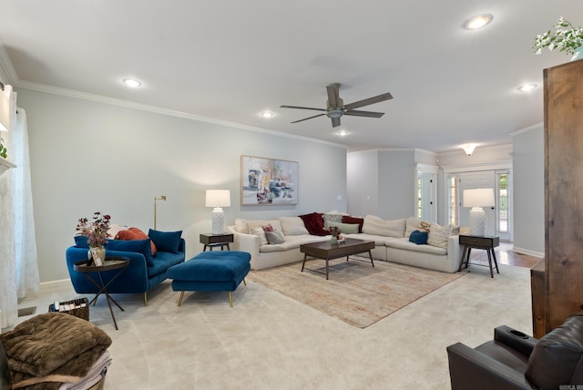 living area with ornamental molding, a ceiling fan, recessed lighting, and light colored carpet