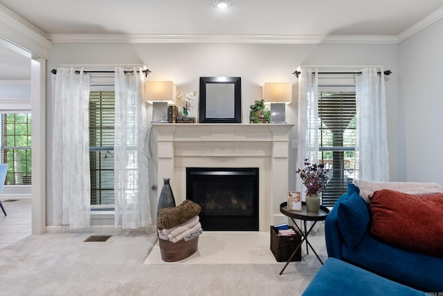 living area featuring crown molding, visible vents, a fireplace, and a wealth of natural light