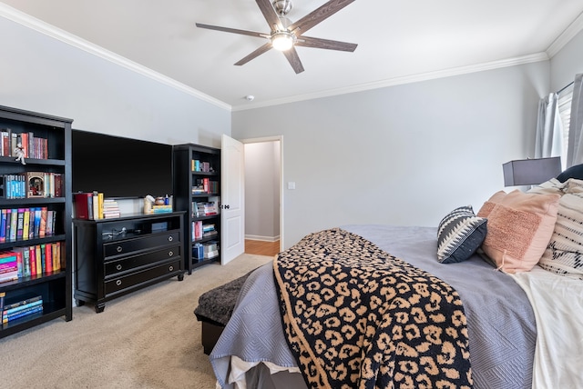 carpeted bedroom featuring crown molding and ceiling fan