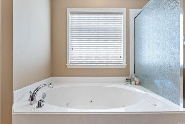 bathroom featuring a tub with jets