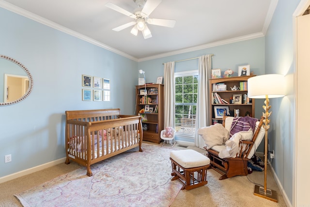 carpeted bedroom with crown molding, baseboards, and ceiling fan