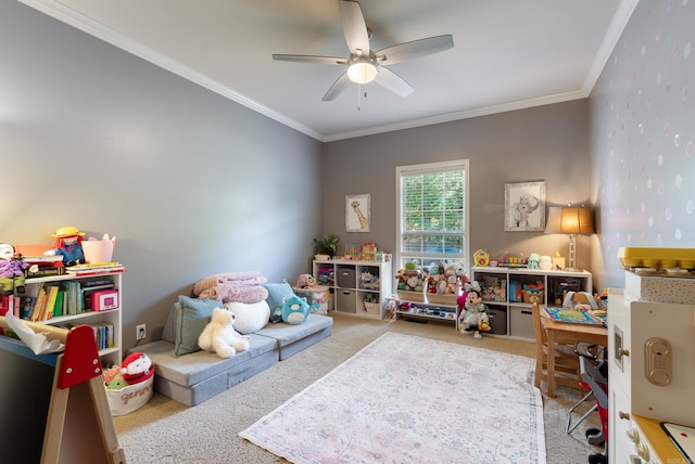 playroom with carpet flooring, a ceiling fan, and crown molding