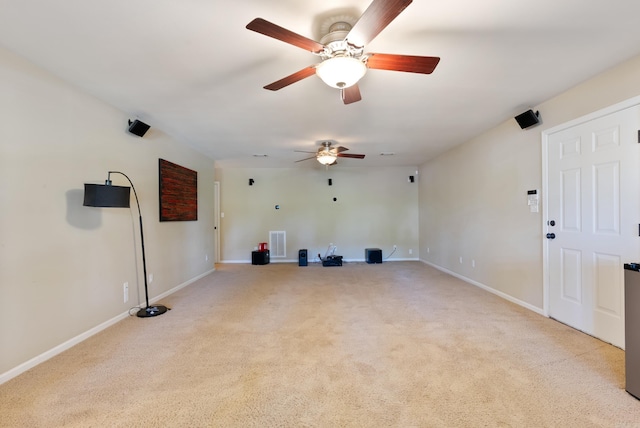 unfurnished room with ceiling fan, visible vents, light carpet, and baseboards