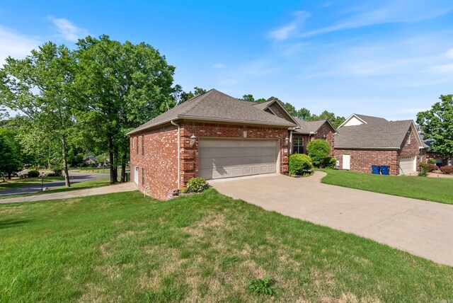ranch-style house featuring a garage, a front yard, roof with shingles, brick siding, and concrete driveway