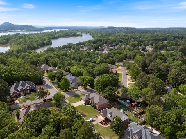 bird's eye view with a water view and a forest view