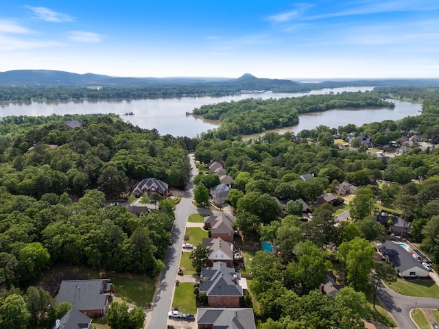 bird's eye view with a water view, a view of trees, and a residential view