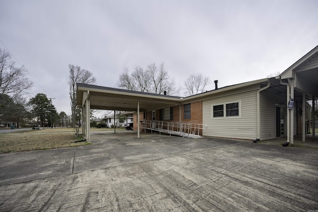 exterior space featuring driveway and an attached carport