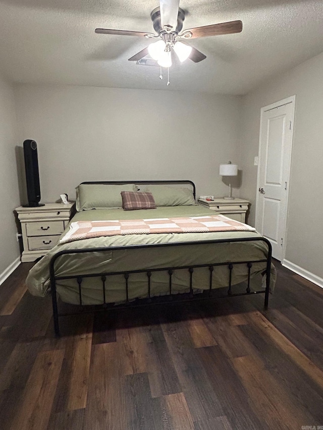 bedroom featuring baseboards, a ceiling fan, a textured ceiling, and dark wood-style flooring