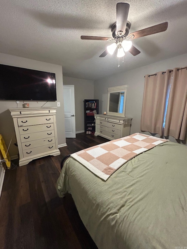 bedroom featuring dark wood-type flooring, a ceiling fan, a textured ceiling, and baseboards