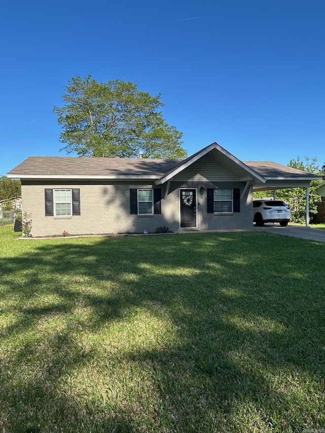 ranch-style home with a front lawn, a carport, and aphalt driveway
