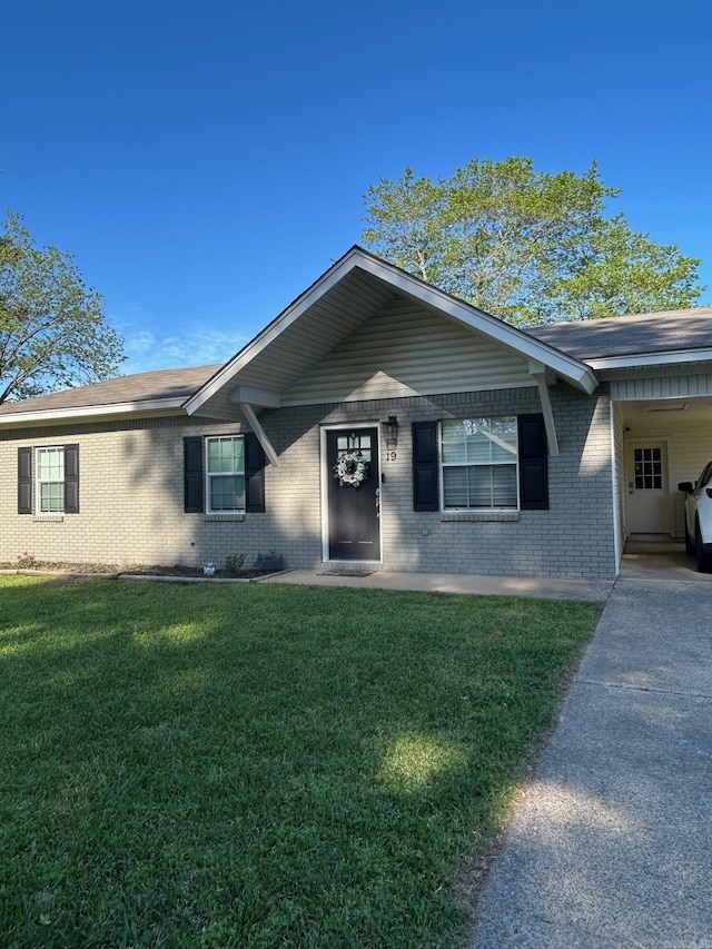 ranch-style home with a front lawn and brick siding