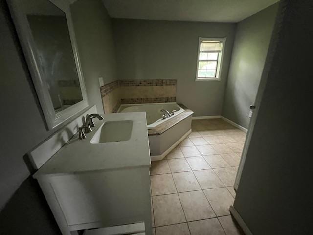 12326 Renshaw Ln, Trumann, AR 72401 - bathroom featuring a garden tub, tile patterned flooring, a sink, and baseboards