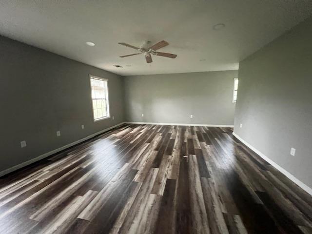 12326 Renshaw Ln, Trumann, AR 72401 - empty room featuring ceiling fan, dark wood-style floors, and baseboards