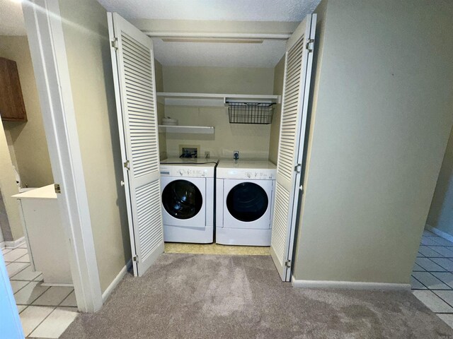 142 Lake Hamilton Dr Unit 204, Hot Springs, AR 71913 - laundry area with laundry area, light colored carpet, light tile patterned floors, washing machine and clothes dryer, and baseboards