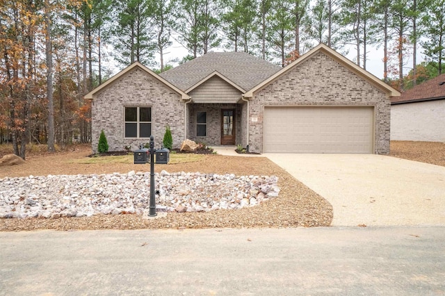 ranch-style home with concrete driveway, brick siding, a shingled roof, and an attached garage