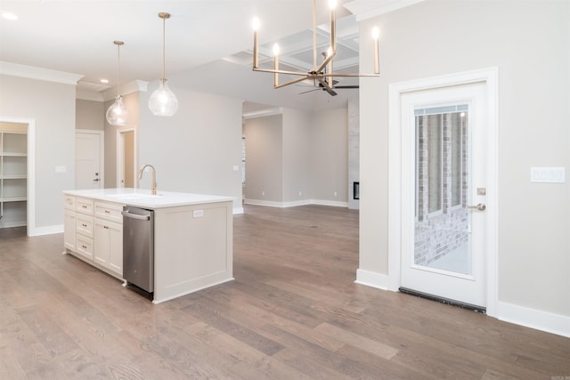 kitchen with wood finished floors, stainless steel dishwasher, white cabinets, a sink, and a center island with sink