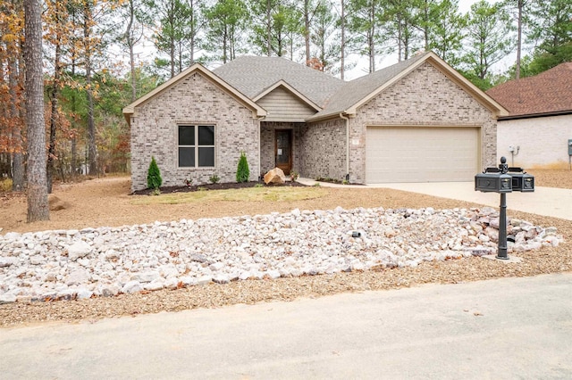 ranch-style house featuring driveway, roof with shingles, brick siding, and a garage
