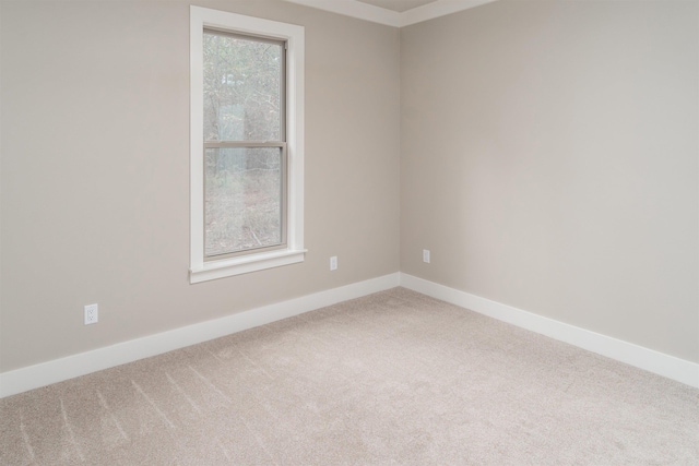 empty room with carpet and baseboards