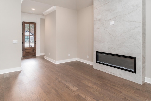 entryway with a high end fireplace, recessed lighting, baseboards, and dark wood finished floors