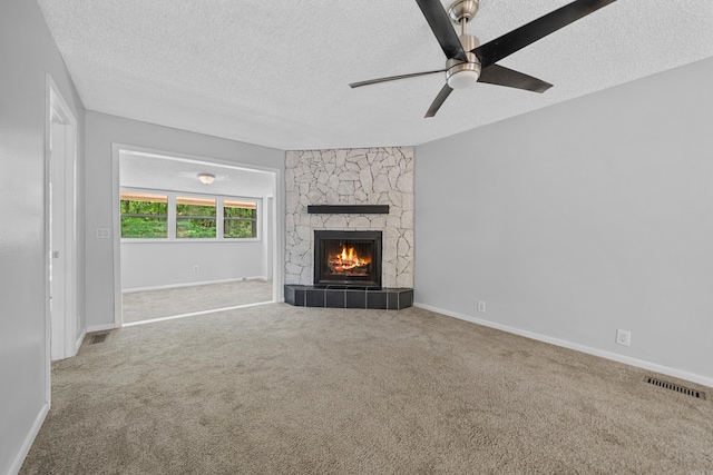73 Perralena Way, Hot Springs Village, AR 71909 - unfurnished living room featuring carpet flooring, a ceiling fan, a textured ceiling, and a fireplace