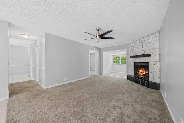 73 Perralena Way, Hot Springs Village, AR 71909 - unfurnished living room with a tile fireplace, carpet floors, ceiling fan, baseboards, and a textured ceiling
