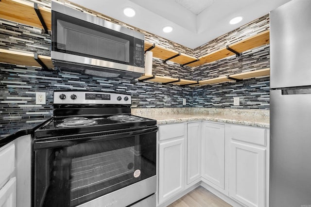 73 Perralena Way, Hot Springs Village, AR 71909 - kitchen with tasteful backsplash, recessed lighting, stainless steel appliances, white cabinets, and light wood-type flooring