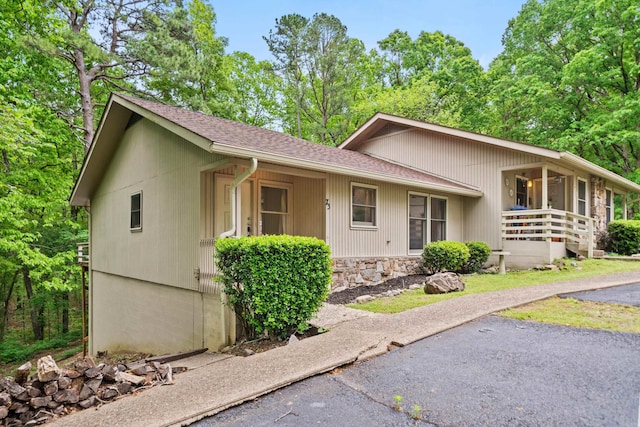 73 Perralena Way, Hot Springs Village, AR 71909 - view of front of home featuring roof with shingles, covered porch, and stone siding