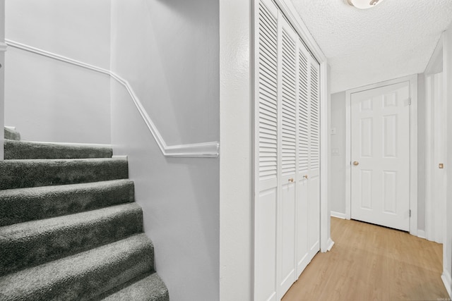 73 Perralena Way, Hot Springs Village, AR 71909 - stairs with a textured ceiling, wood finished floors, and baseboards