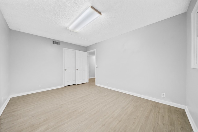 73 Perralena Way, Hot Springs Village, AR 71909 - unfurnished room featuring baseboards, visible vents, wood finished floors, and a textured ceiling