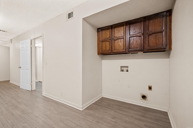 73 Perralena Way, Hot Springs Village, AR 71909 - laundry area with hookup for an electric dryer, cabinet space, hookup for a washing machine, visible vents, and a textured ceiling