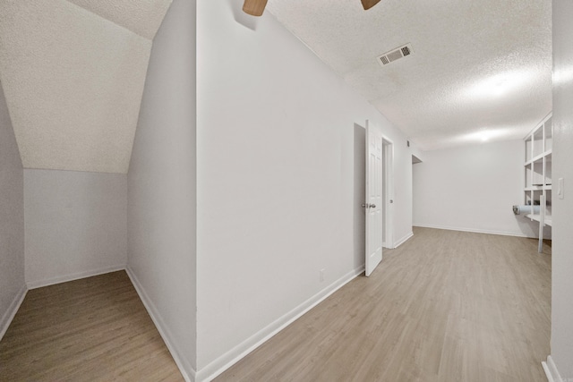 73 Perralena Way, Hot Springs Village, AR 71909 - corridor with visible vents, vaulted ceiling, baseboards, a textured ceiling, and wood finished floors