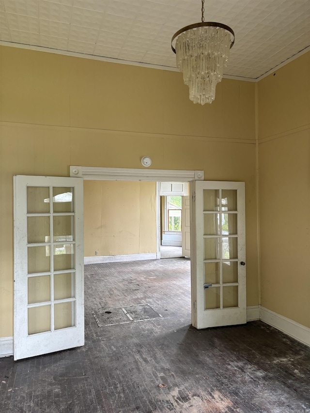 307 E Center Ave, Searcy, AR 72143 - unfurnished room featuring a high ceiling, a notable chandelier, and french doors