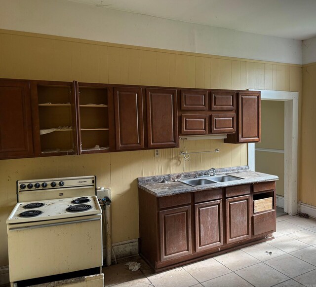 307 E Center Ave, Searcy, AR 72143 - kitchen with electric range, dark brown cabinetry, light tile patterned flooring, and a sink