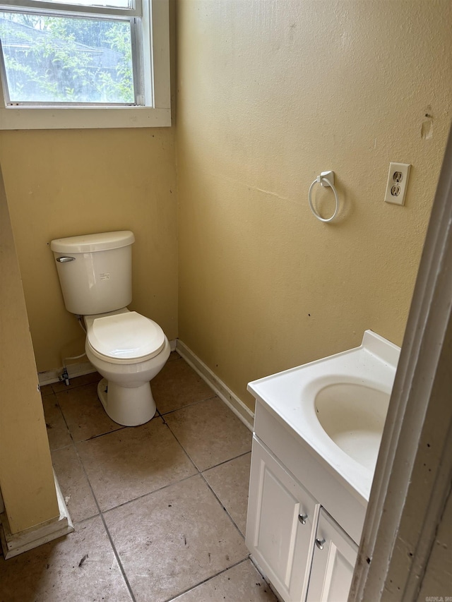 307 E Center Ave, Searcy, AR 72143 - half bath featuring tile patterned floors, baseboards, toilet, and vanity