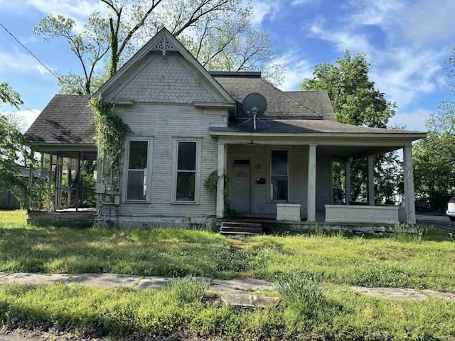 307 E Center Ave, Searcy, AR 72143 - view of front of home with roof with shingles and a porch