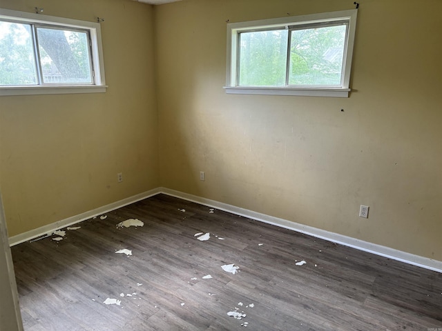 307 E Center Ave, Searcy, AR 72143 - spare room with baseboards, wood finished floors, and a healthy amount of sunlight