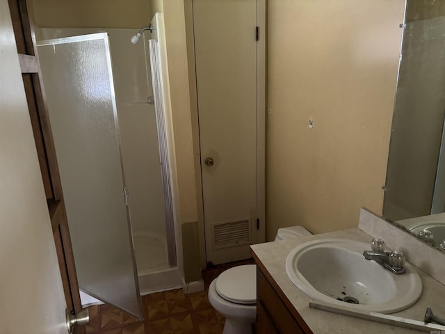 307 E Center Ave, Searcy, AR 72143 - bathroom with toilet, visible vents, vanity, and a stall shower