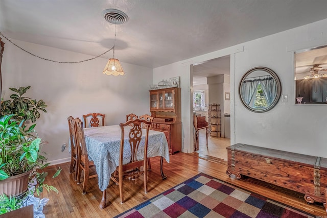 dining area featuring visible vents and wood finished floors