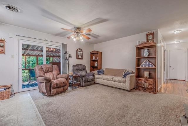 living room featuring visible vents and ceiling fan