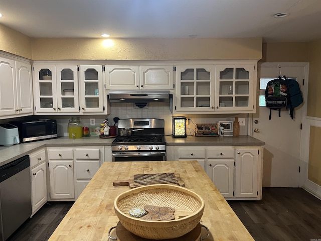 190 E Poplar St, Piggott, AR 72454 - kitchen with wood counters, under cabinet range hood, glass insert cabinets, and appliances with stainless steel finishes