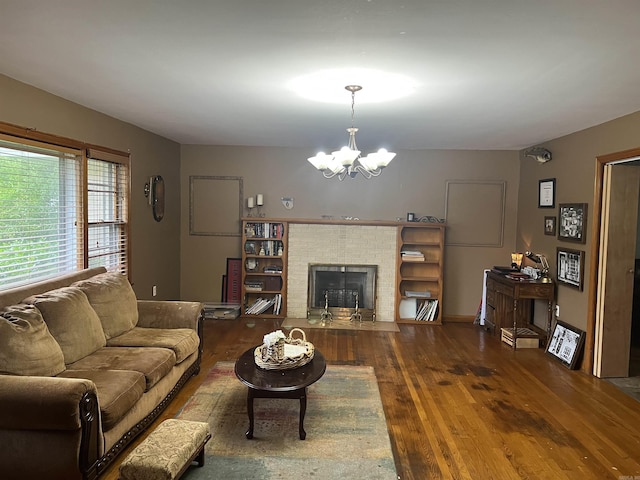 190 E Poplar St, Piggott, AR 72454 - living room featuring a chandelier, wood finished floors, and a fireplace